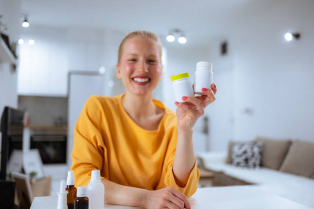Caucasian woman holding vitamin bottle